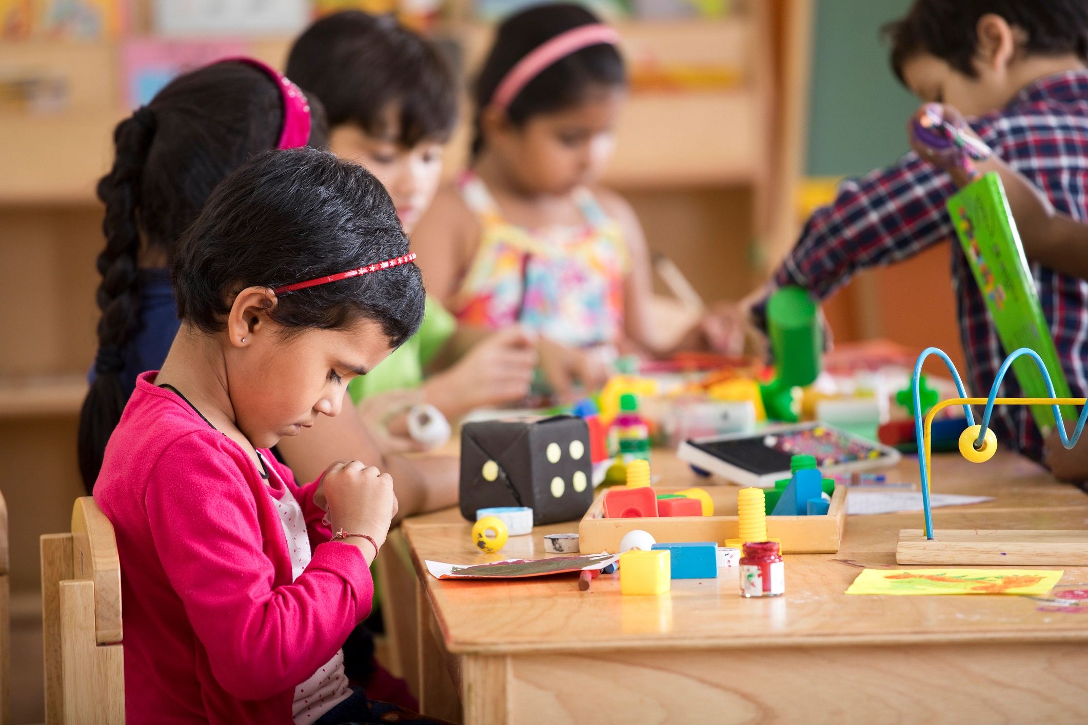 Children drawing and painting at preschool