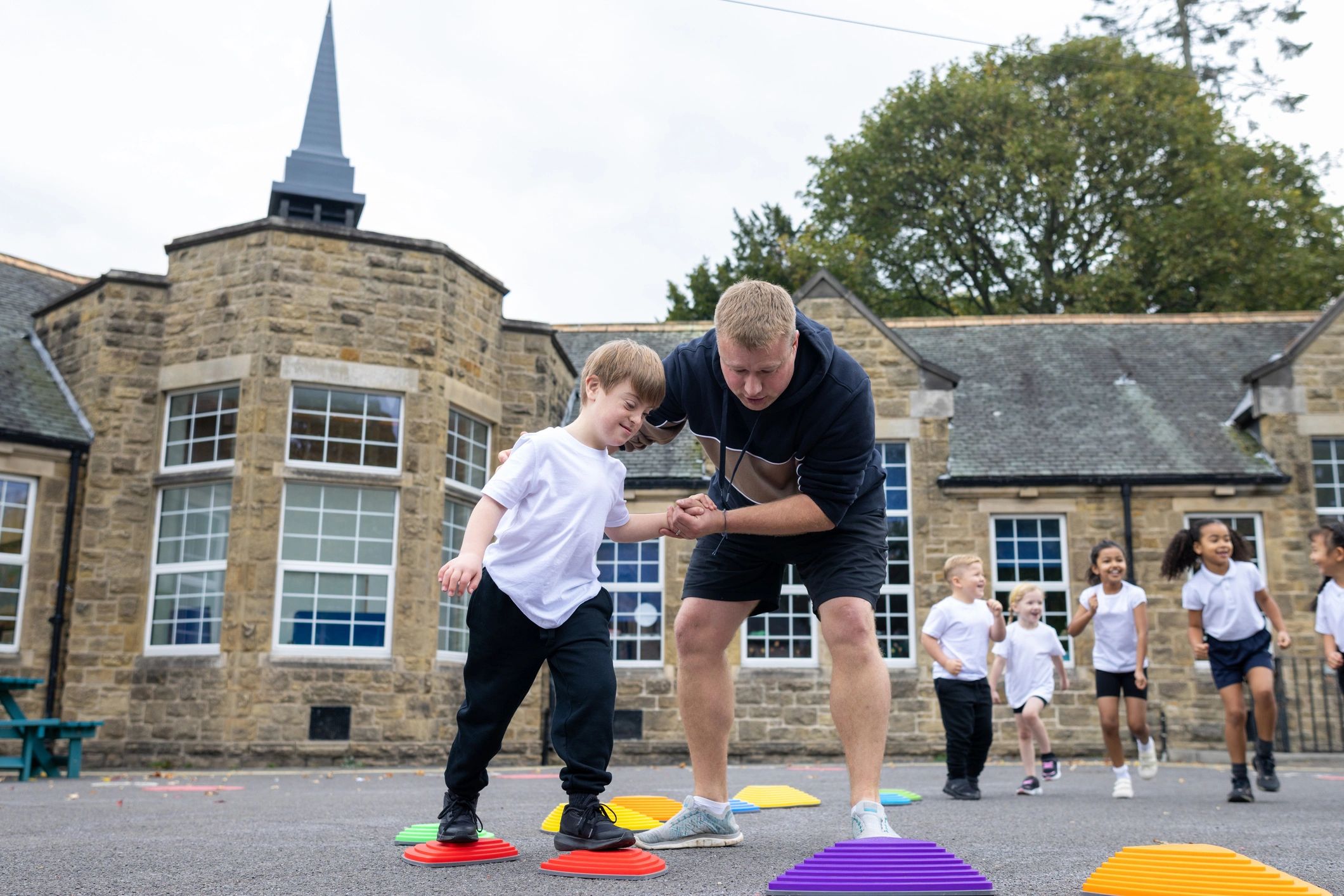 Teacher guiding children during outdoor activity